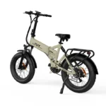 Beige folding electric bike with wide off-road tires, front suspension, rear rack, and kickstand photographed against a white backdrop.