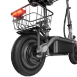 Close-up of an electric scooter's rear section: large wheel, drive hub, and a cargo basket with a red rear light above it.