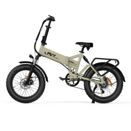 Beige compact folding electric bicycle with fat tires, front suspension, rear rack, kickstand, and mid-motor drivetrain